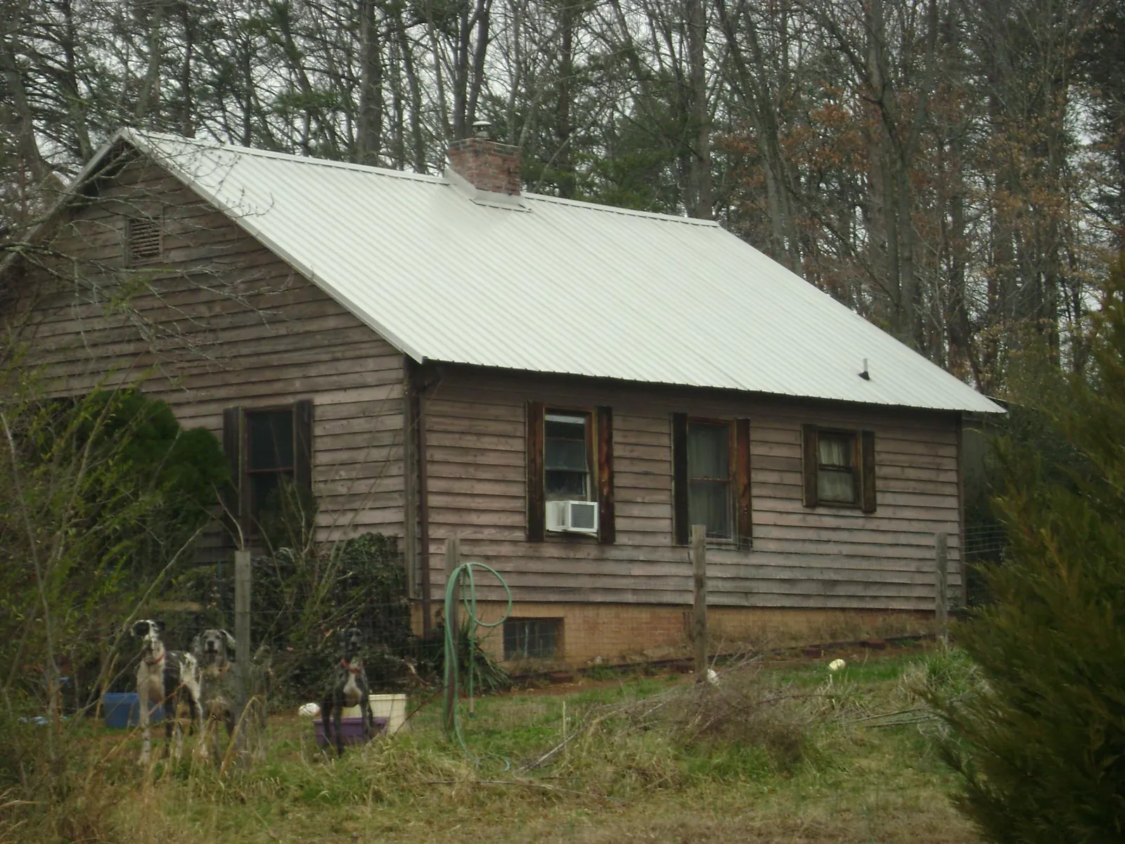 White metal roof on an old wood sided farmhouse, from a Asphalt Shingle Roof Repair job in Goshen